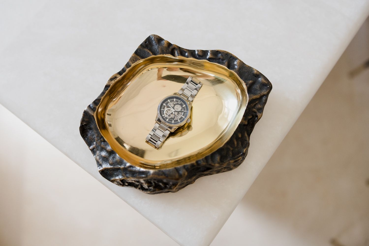 Oyster shells on a white marble surface showcasing exquisite jewelry presentation and styling.
