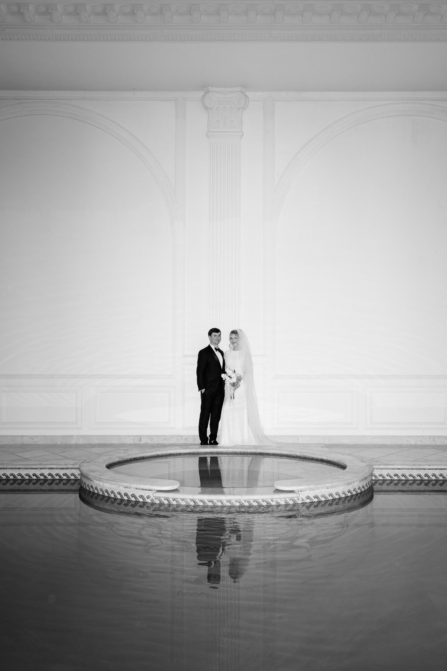 A black and white minimalist wedding photo series showing a couple reflected in a circular mirrored surface. chateau saint georges france
