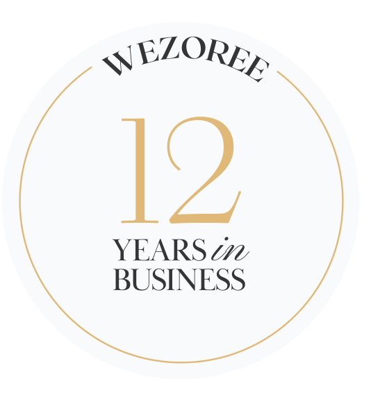 Gold circular badges showing business milestones and years of experience with clean minimalist design.