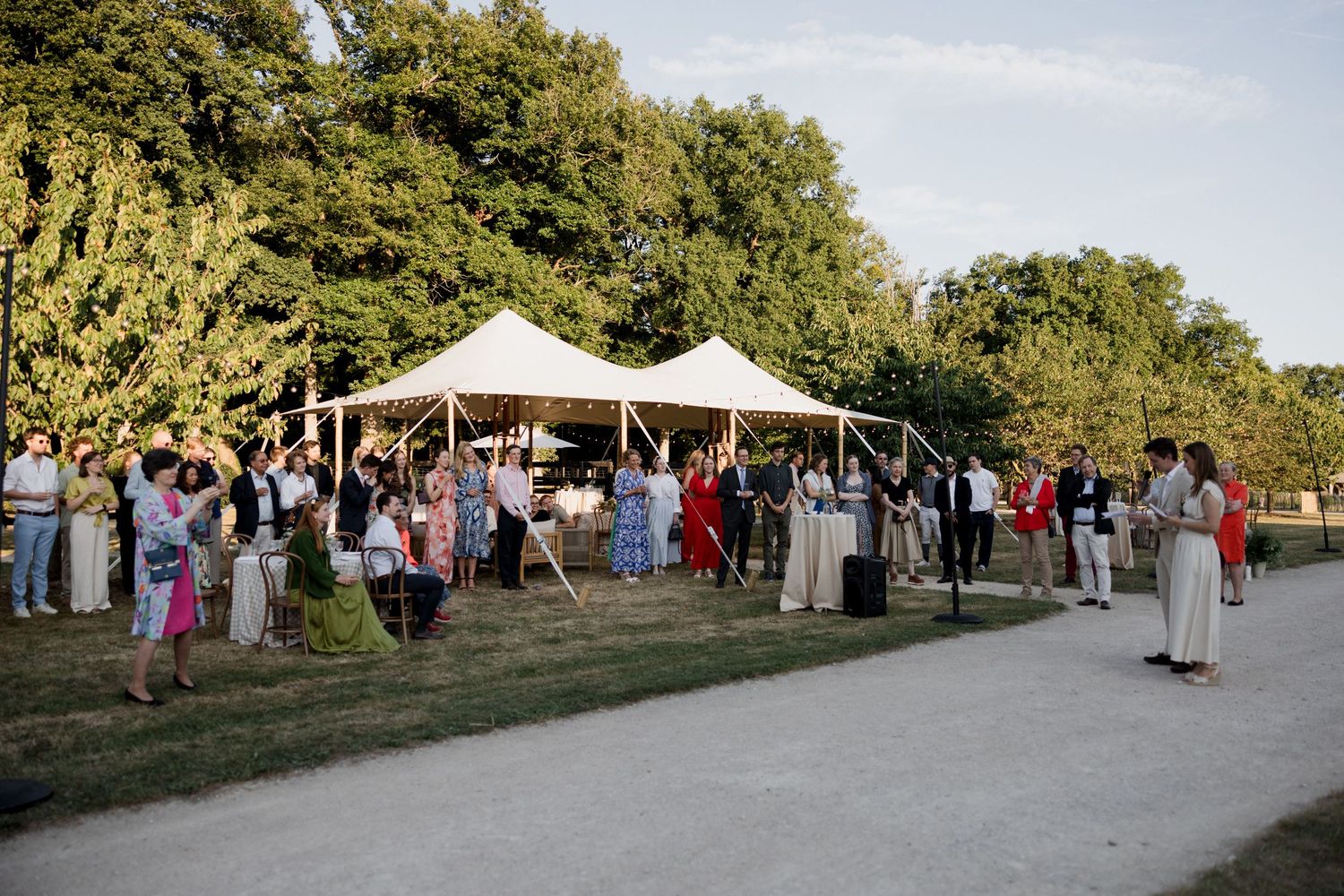 A series of outdoor event photos showing tents, vendor booths, and people gathering at a festival in a park setting.