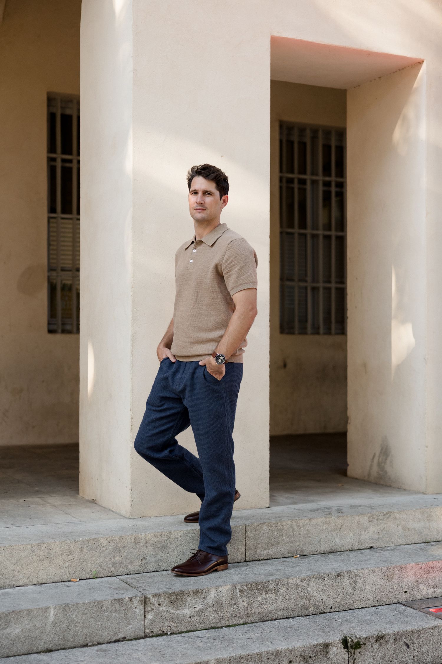 A series of photos capturing someone in casual attire posing against a bright architectural backdrop with columns.