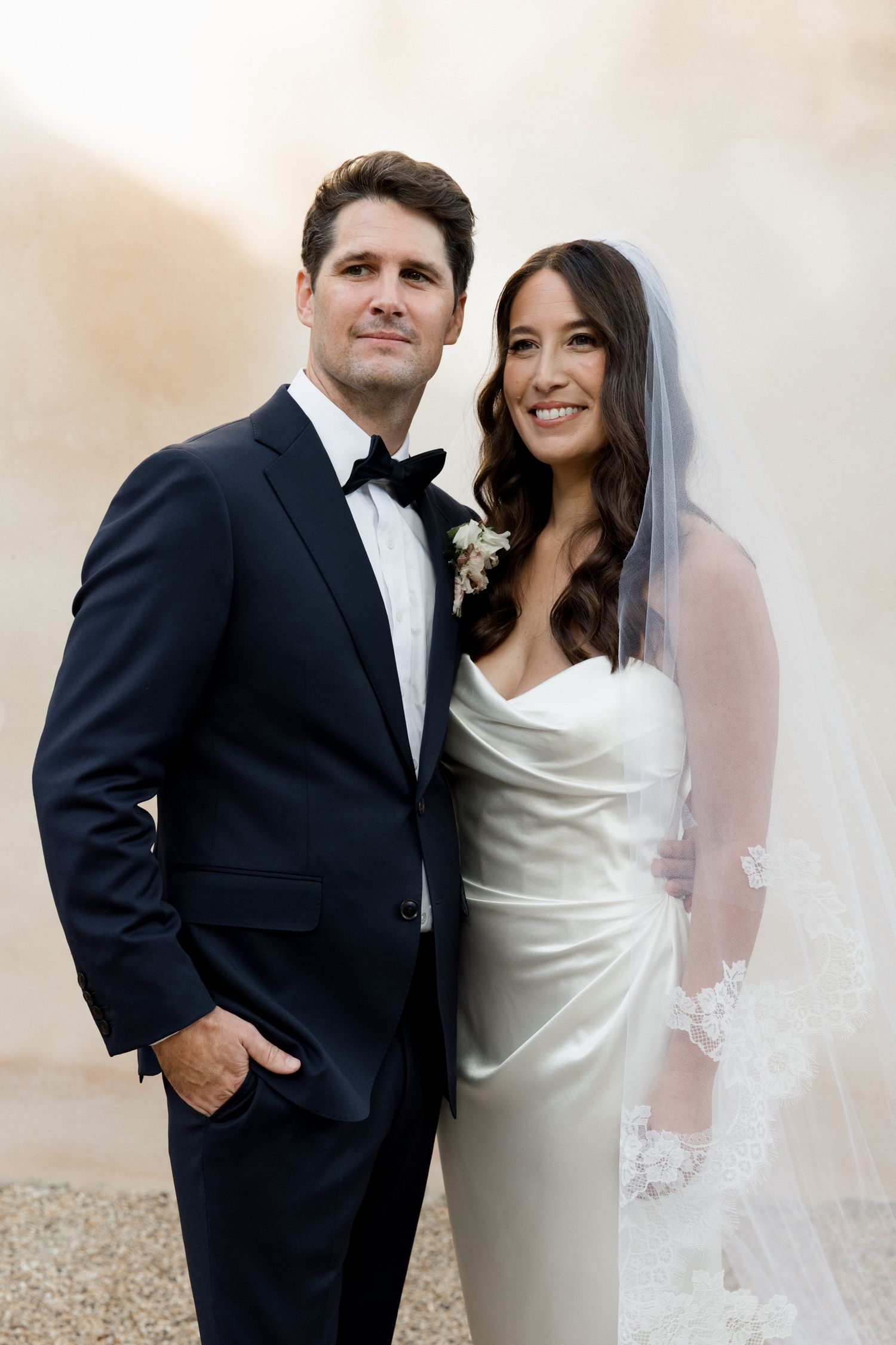 A bride in white dress and groom in black tuxedo pose together in four romantic wedding portraits. wedding photographer france