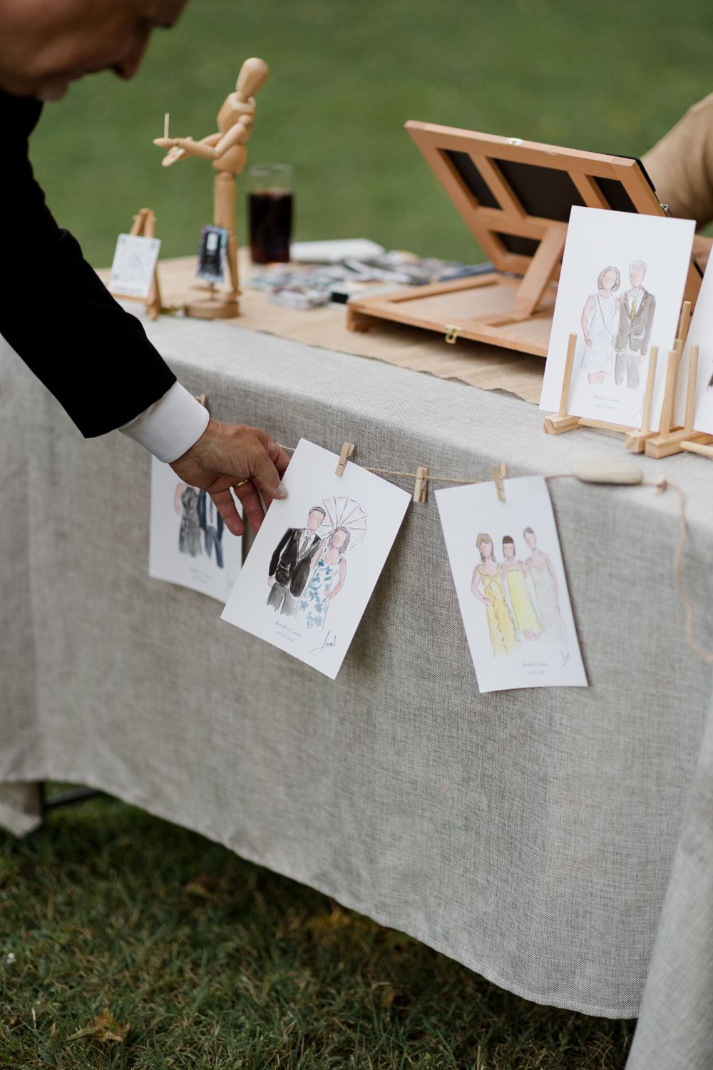 Fashion illustrations and dress sketches arranged on a linen tablecloth for design review and presentation. Aurora Artiste