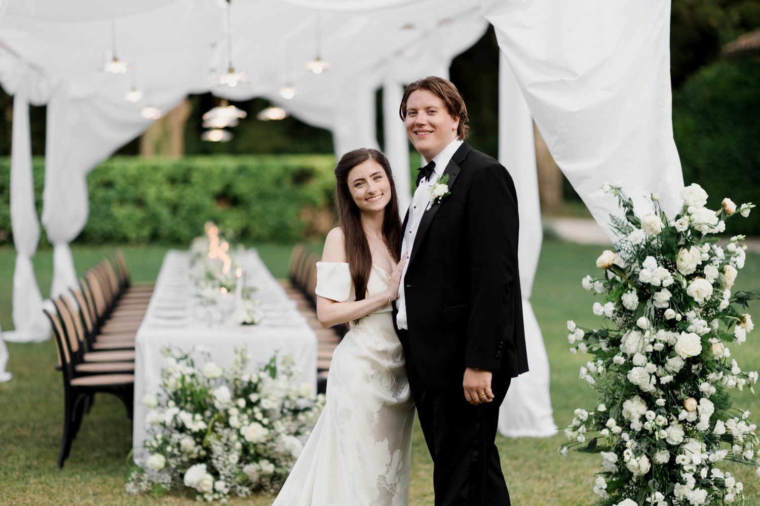 A collection of elegant outdoor wedding photos featuring couples celebrating in a lush garden setting with white floral decor.