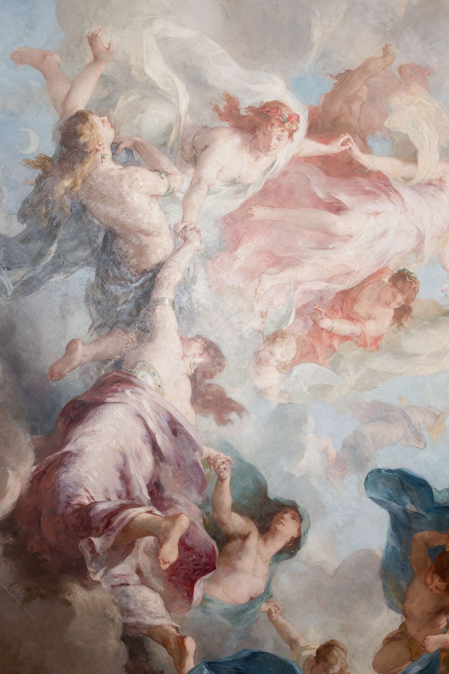 Baroque ceiling painting depicting ethereal figures and angels floating among soft clouds in pastel pink and blue tones.