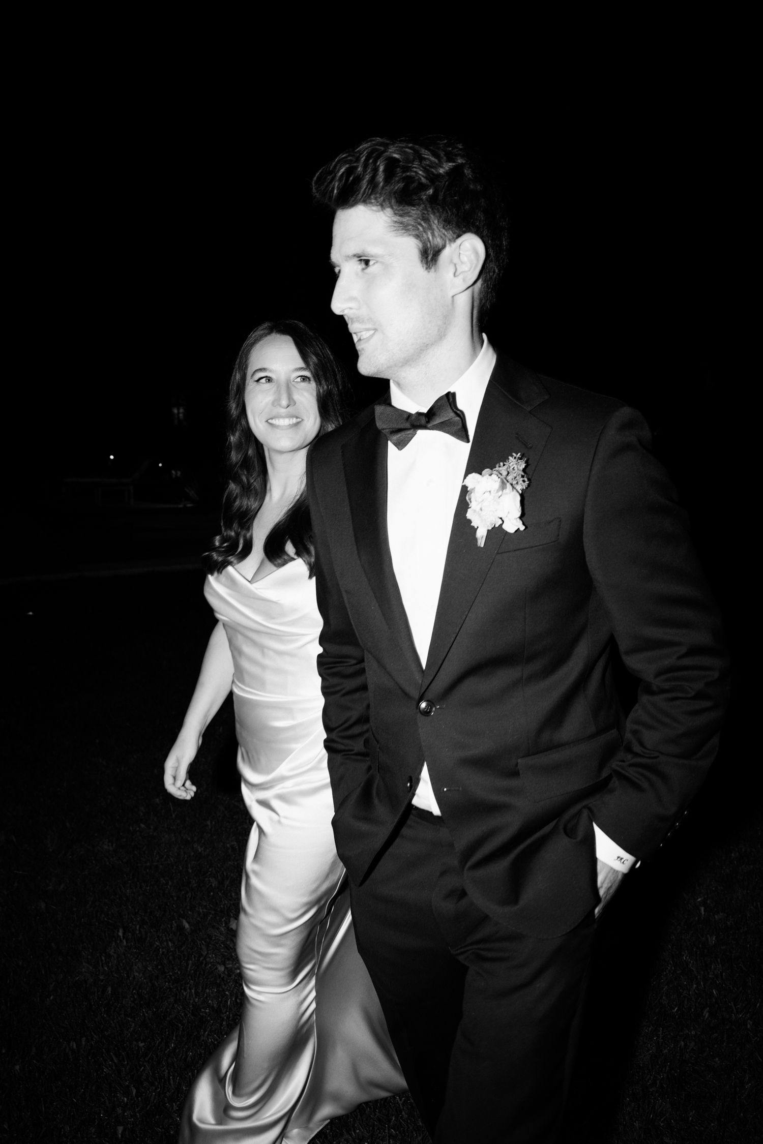 A couple in formal attire, with the woman in a white dress and man in black tuxedo, dancing together at an event. wedding photographer