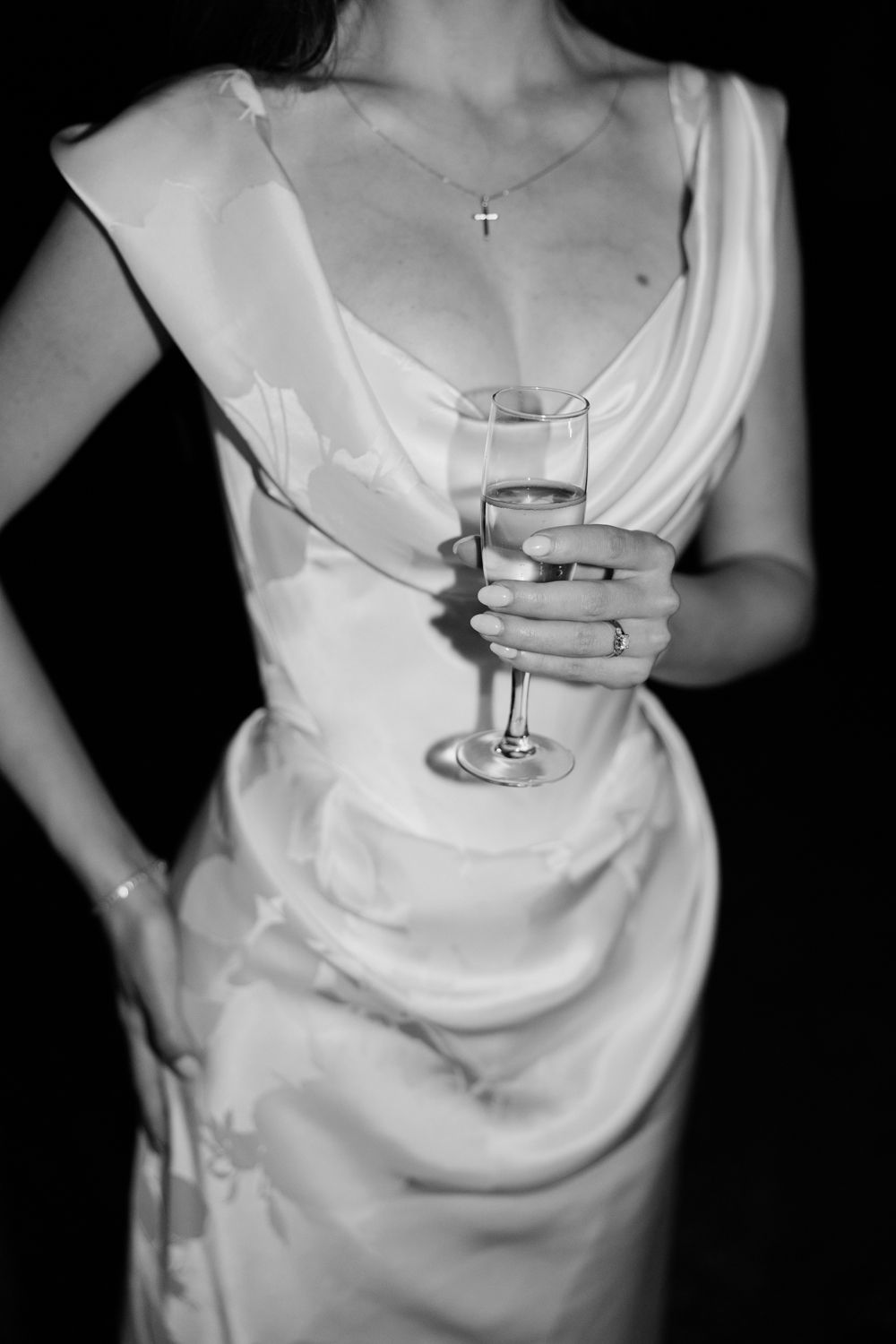 A series of cropped black and white photos showing someone in a white top holding a wine glass.