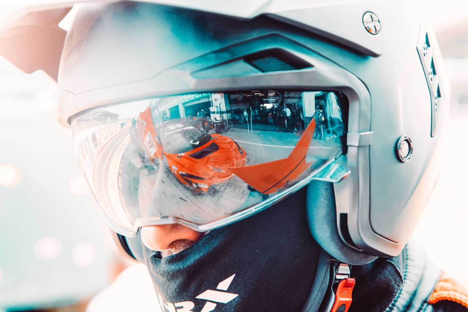 A group of firefighters in white helmets and safety gear stand in formation against a blurred background.