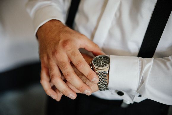 A sequence of images showing hands adjusting a luxury watch band and clasp mechanism.