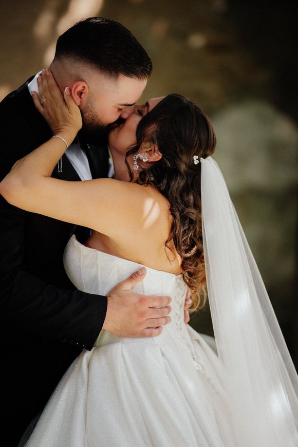 A romantic series of wedding photos showing tender embraces between newlyweds with a flowing white veil.