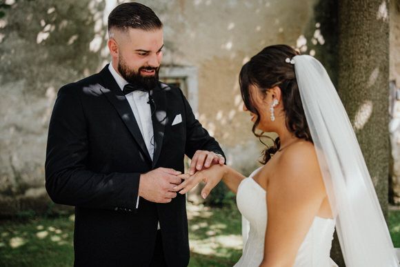 A joyful wedding couple shares an intimate moment together outdoors during their special day.