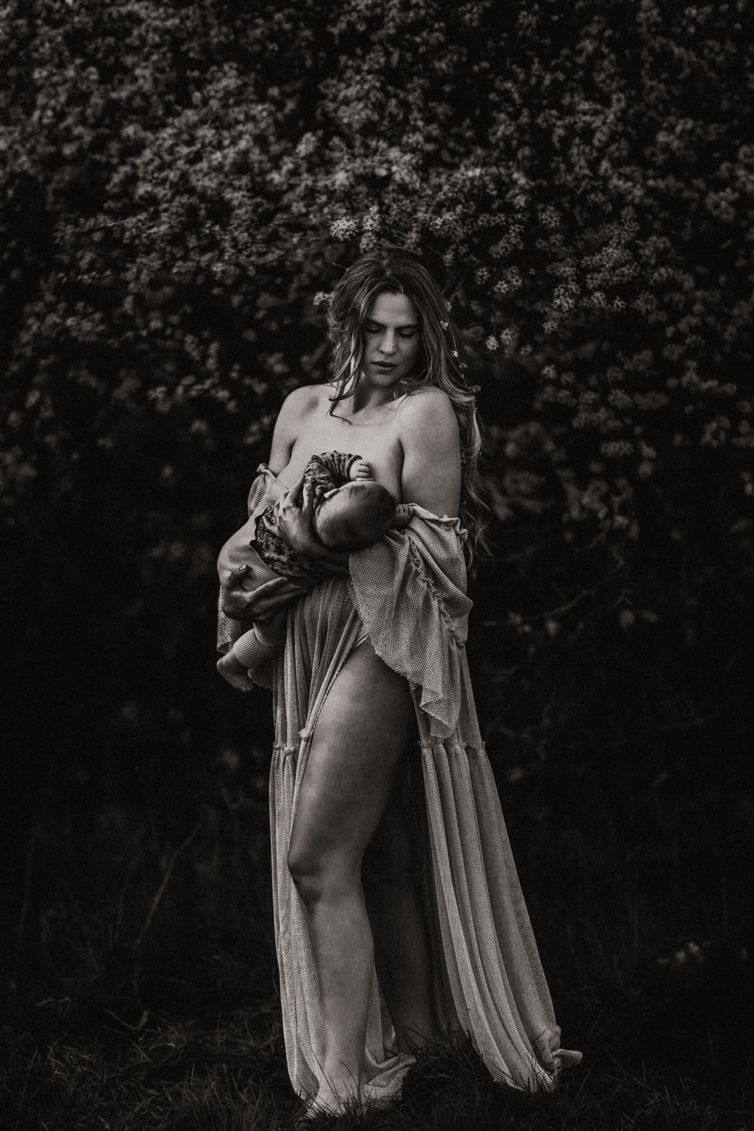 A dramatic black and white portrait series showing a figure in flowing fabric against a dark background.