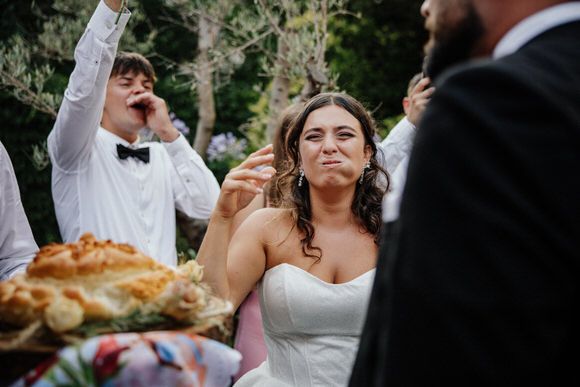 Hochzeitsfotograf Boudier & Koeller – Hochzeitsfeier mit Gästen und traditioneller Brotzeremonie im Garten.
