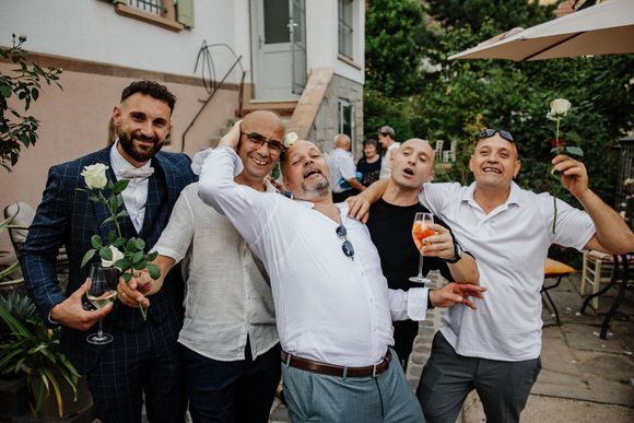 Hochzeitsfotograf Boudier & Koeller – Gäste genießen Drinks und feiern zusammen auf Outdoor-Patio.