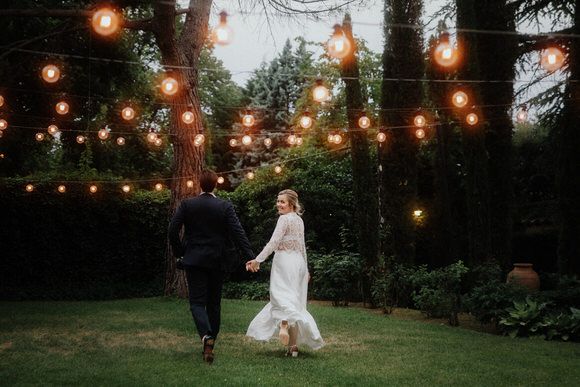Lichterketten erhellen ein bewaldetes Hochzeitsgelände in der Abenddämmerung – magisch heiraten im Morrhof.