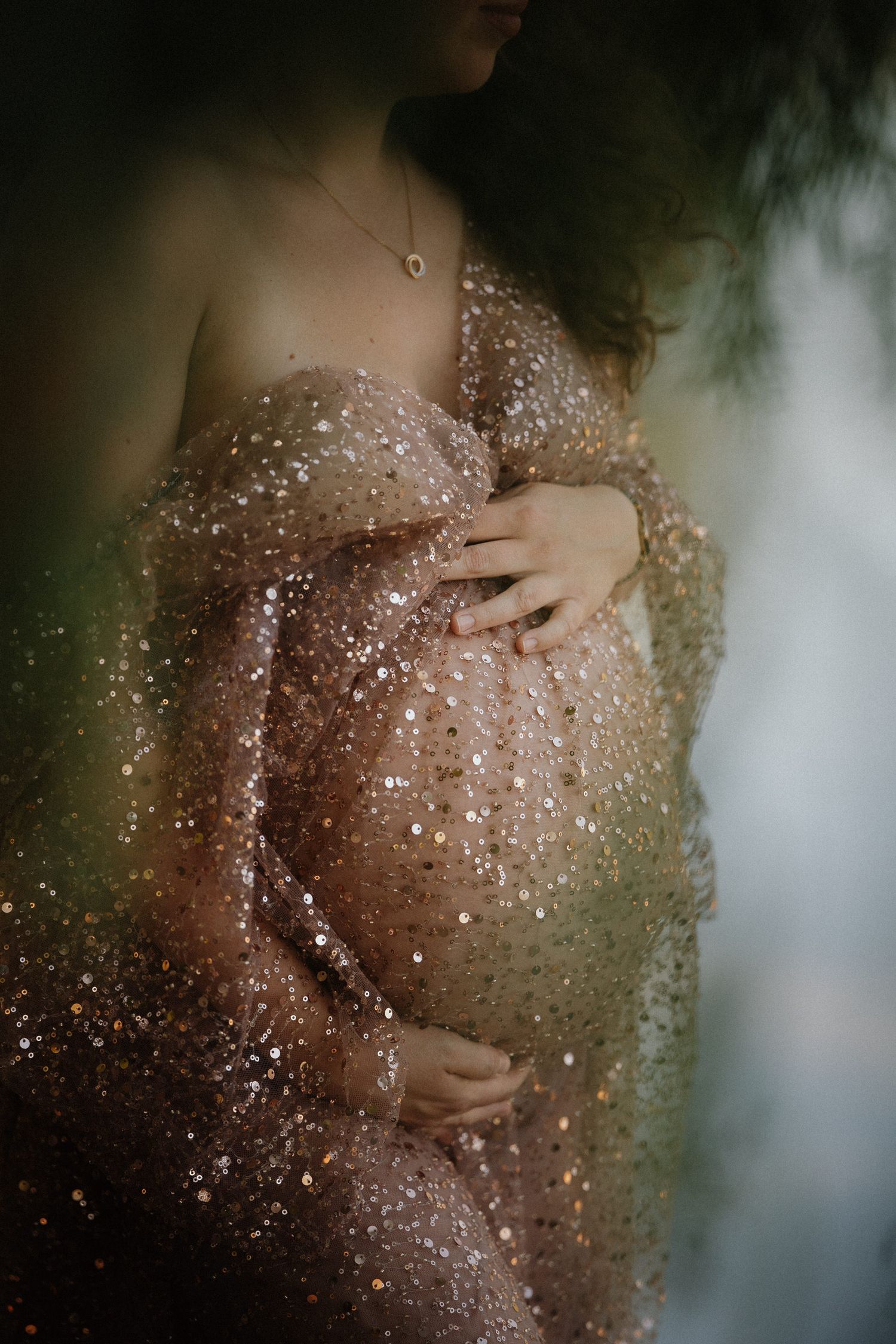 A series of artistic close-up photos showing water droplets and hands against a blurred natural background.
