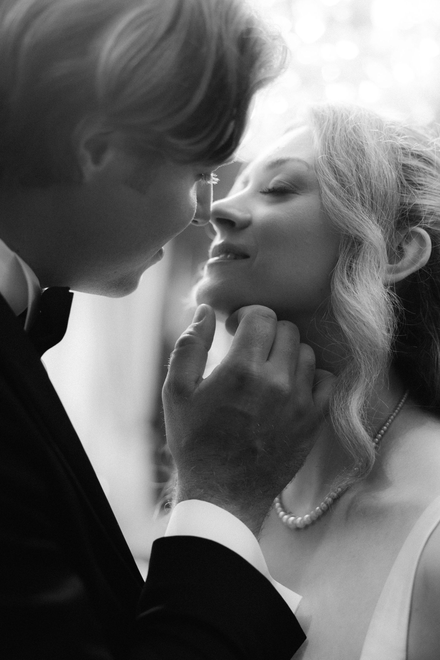 A romantic black and white photo series showing intimate close-up moments between two people in an artistic style.