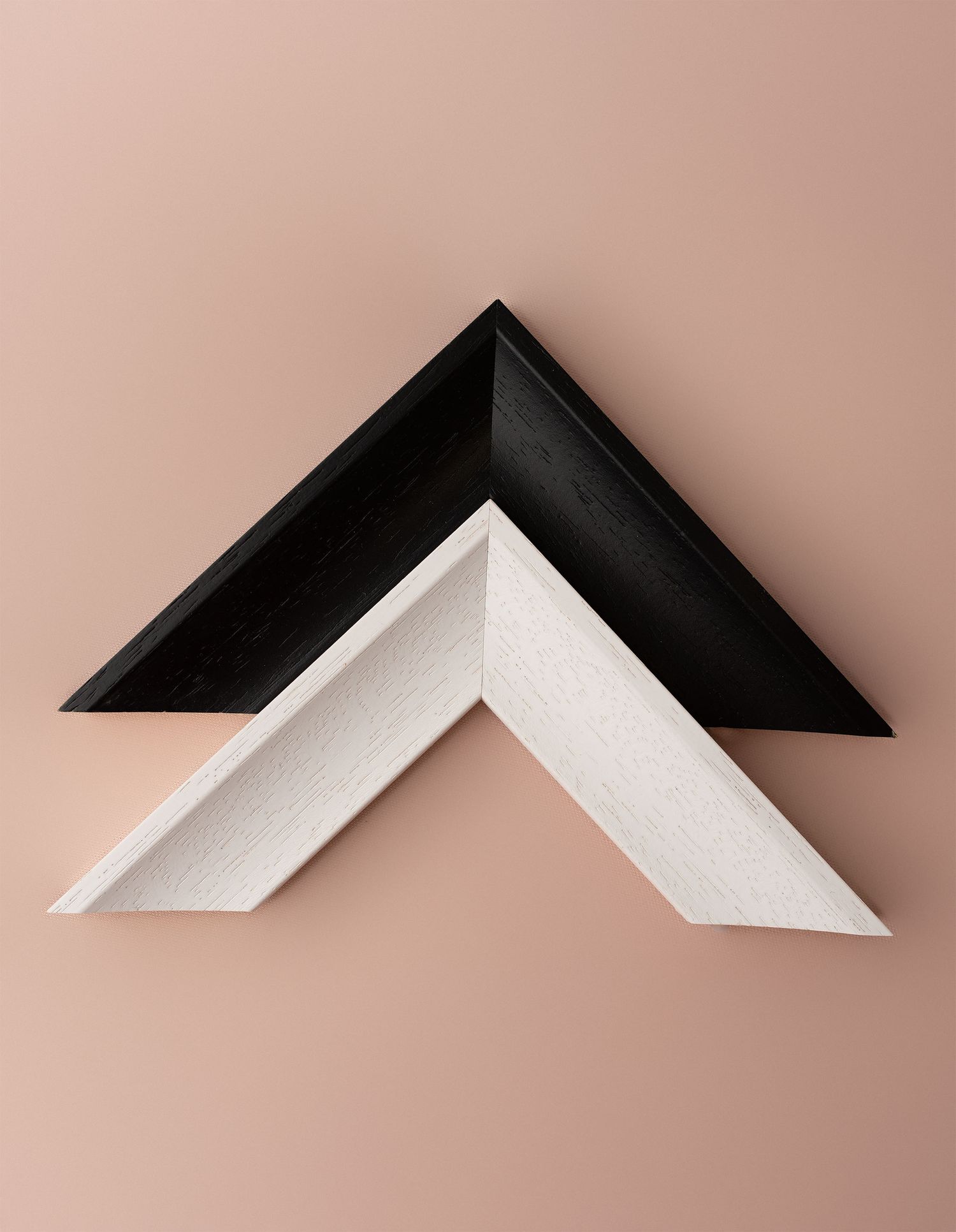 Minimalist black and white geometric shapes forming an abstract pattern against a pink background.