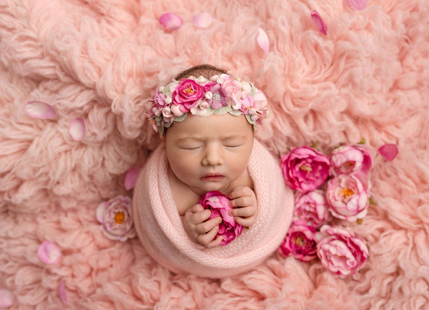 Peaceful newborn wrapped in soft pastels capturing the pure innocence and delicate beauty of your baby's first precious days.