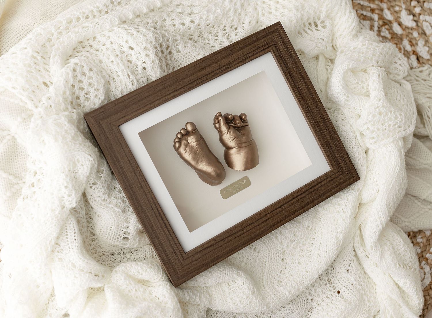 Bronze cast baby feet and hands in a dark wood shadow box frame by Ada Studio Oban