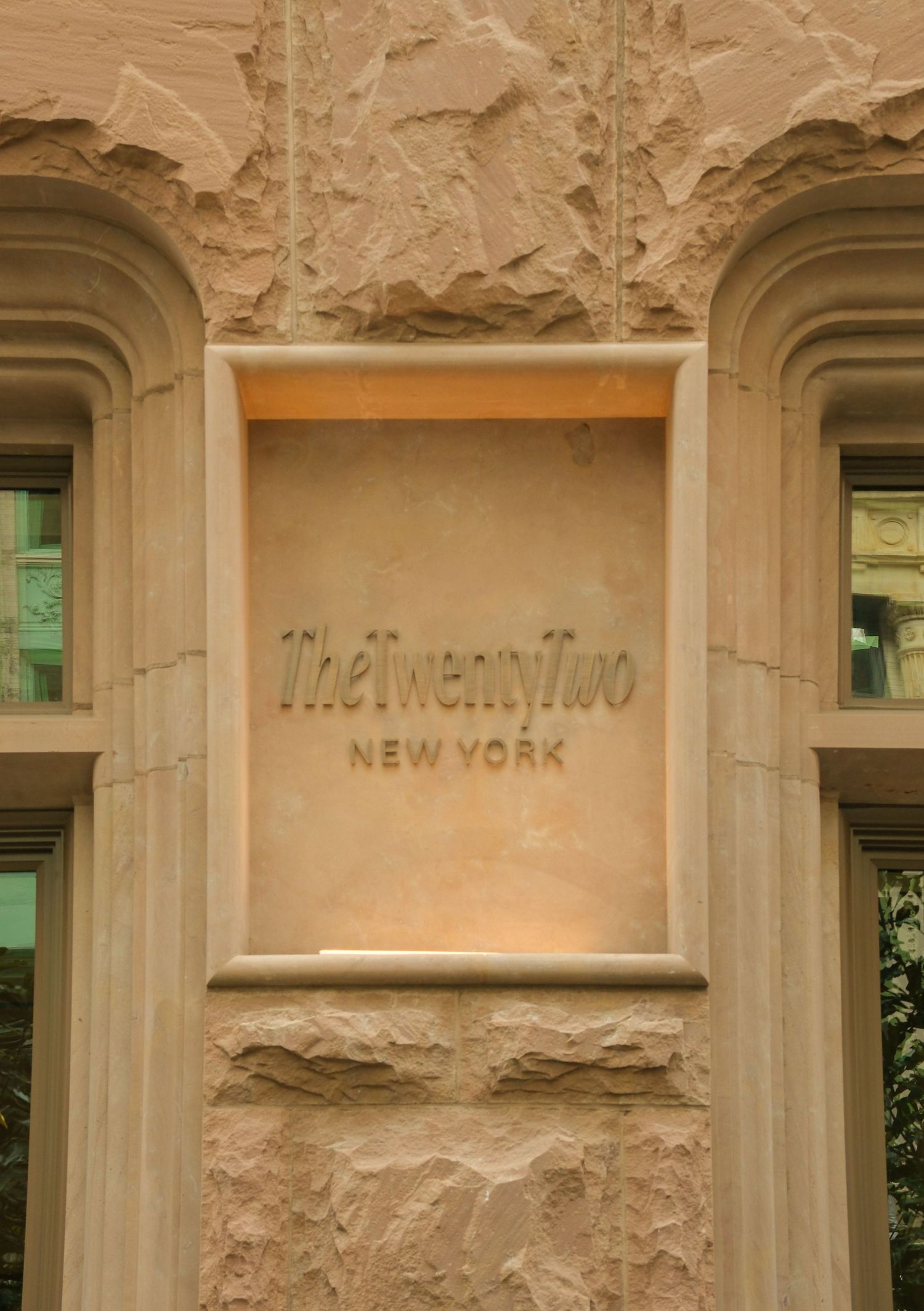 The Twenty Two New York hotel exterior stone facade entrance sign in Manhattan.