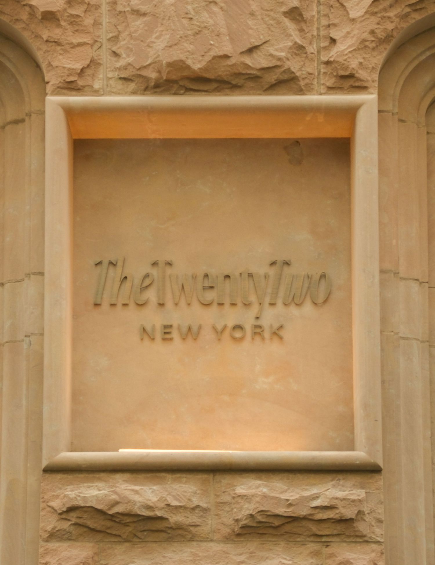 The Twenty Two New York boutique hotel engraved stone entrance sign detail.