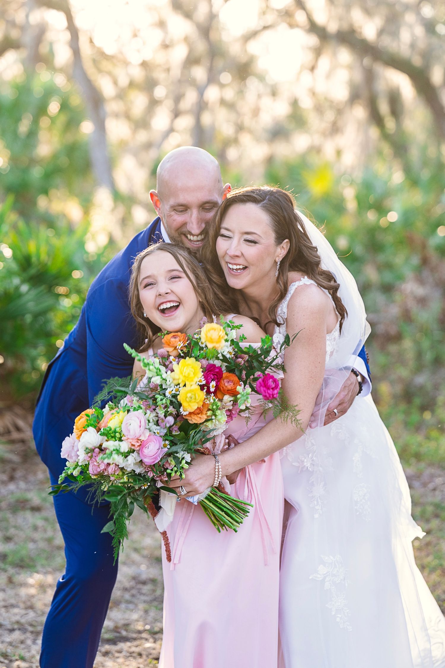 A joyful wedding moment outdoors with a bright and colorful bouquet of mixed flowers against a natural backdrop.