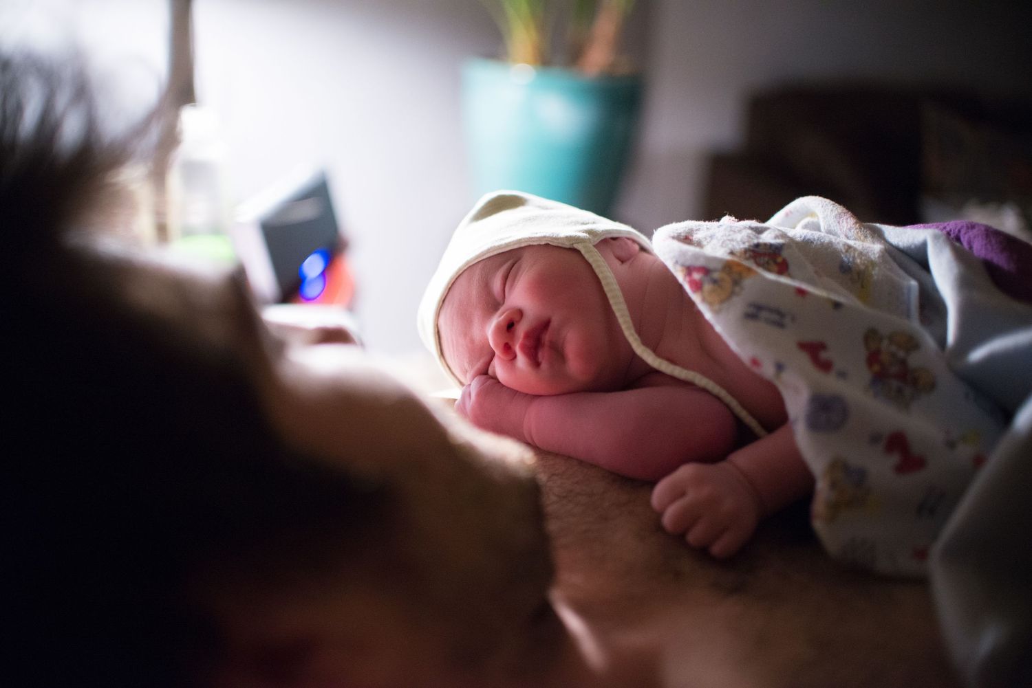 Close-up view of a newborn baby's tiny feet wrapped in soft white blankets.