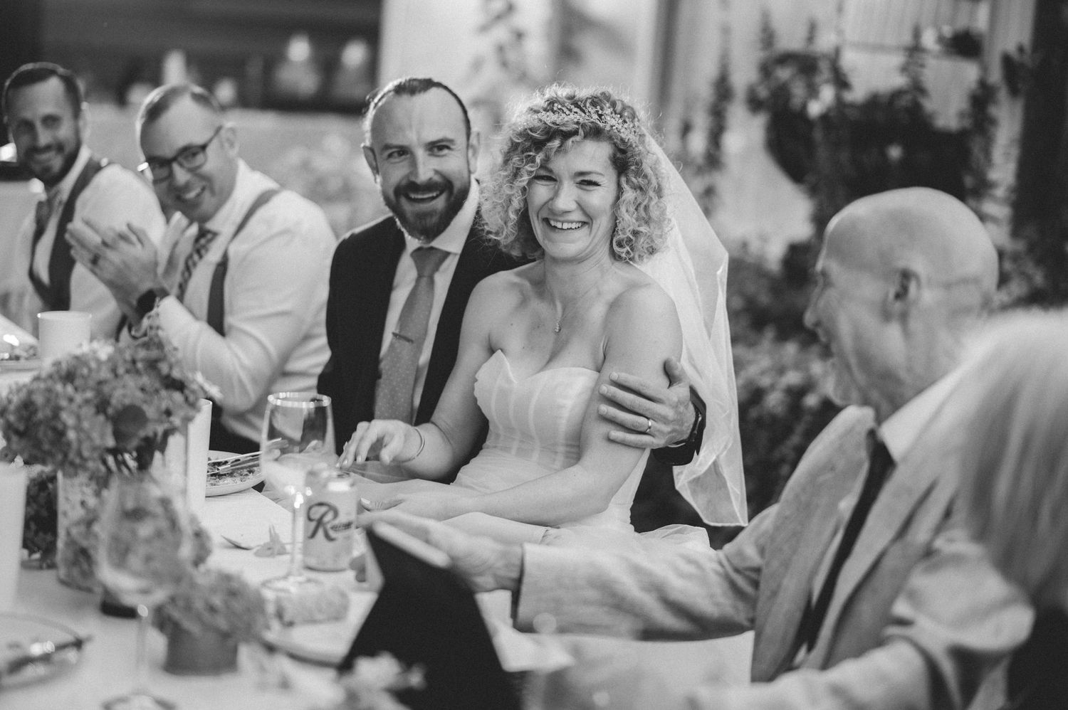 Black and white candid shots of wedding reception guests enjoying conversations.
