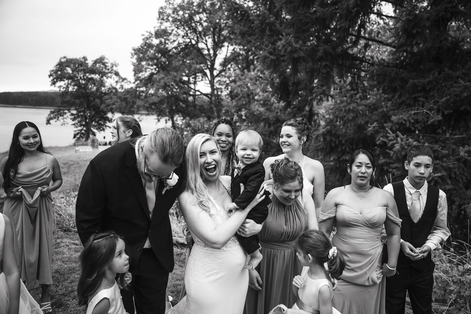 Black and white photo series showing joyful reactions and candid moments at an outdoor wedding celebration.