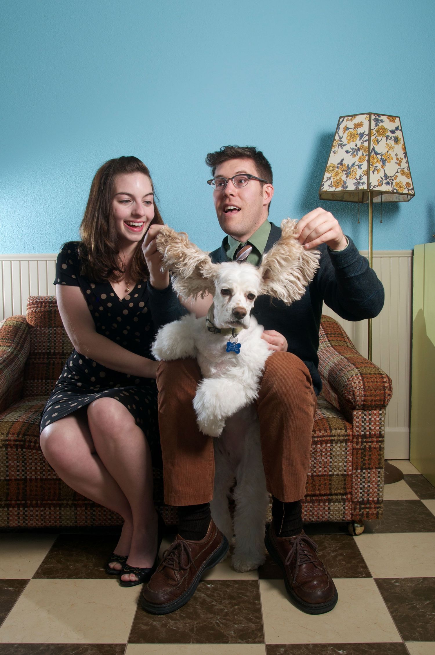 A sequence of photos showing a couple sitting on a couch with their small white dog in various playful poses.