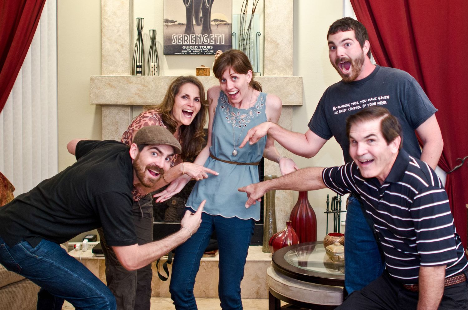 Friends laughing and having fun together while playing games and socializing in a living room setting.