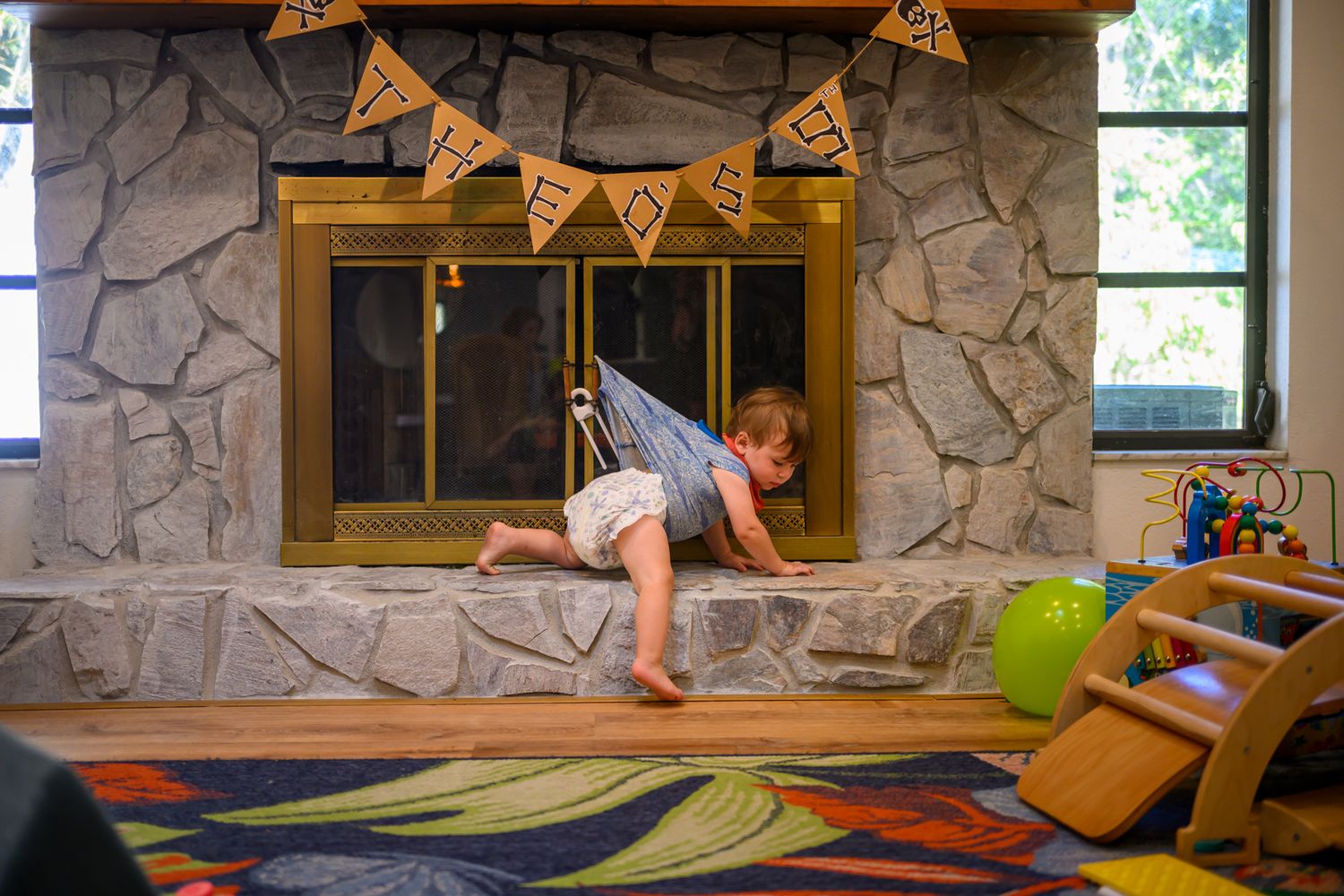 A sequence of four photos showing someone practicing gymnastics moves on a low beam in a stone-walled room.