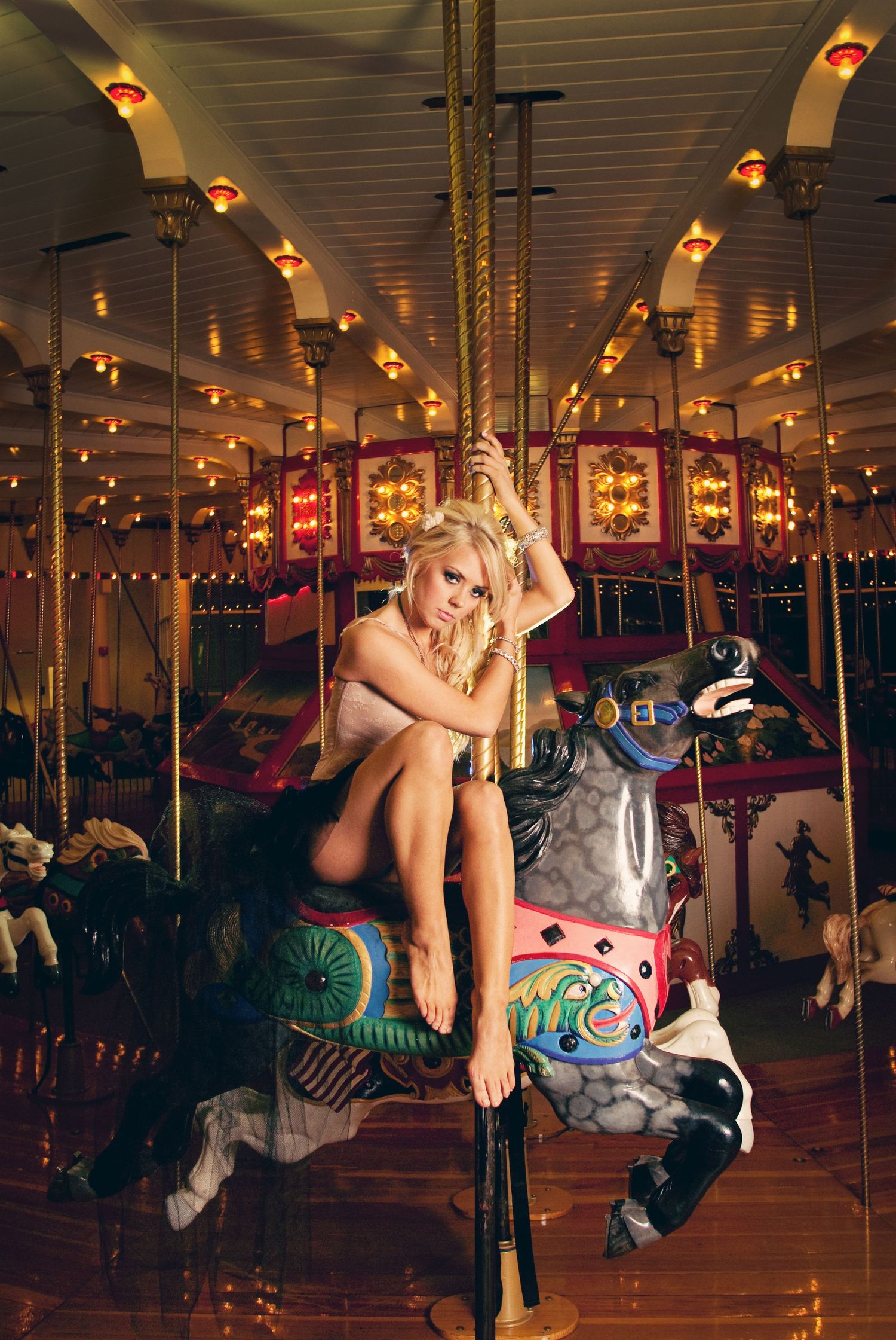 A carousel horse sequence shows a playful figure leaping and posing on a traditional merry-go-round in warm lighting.