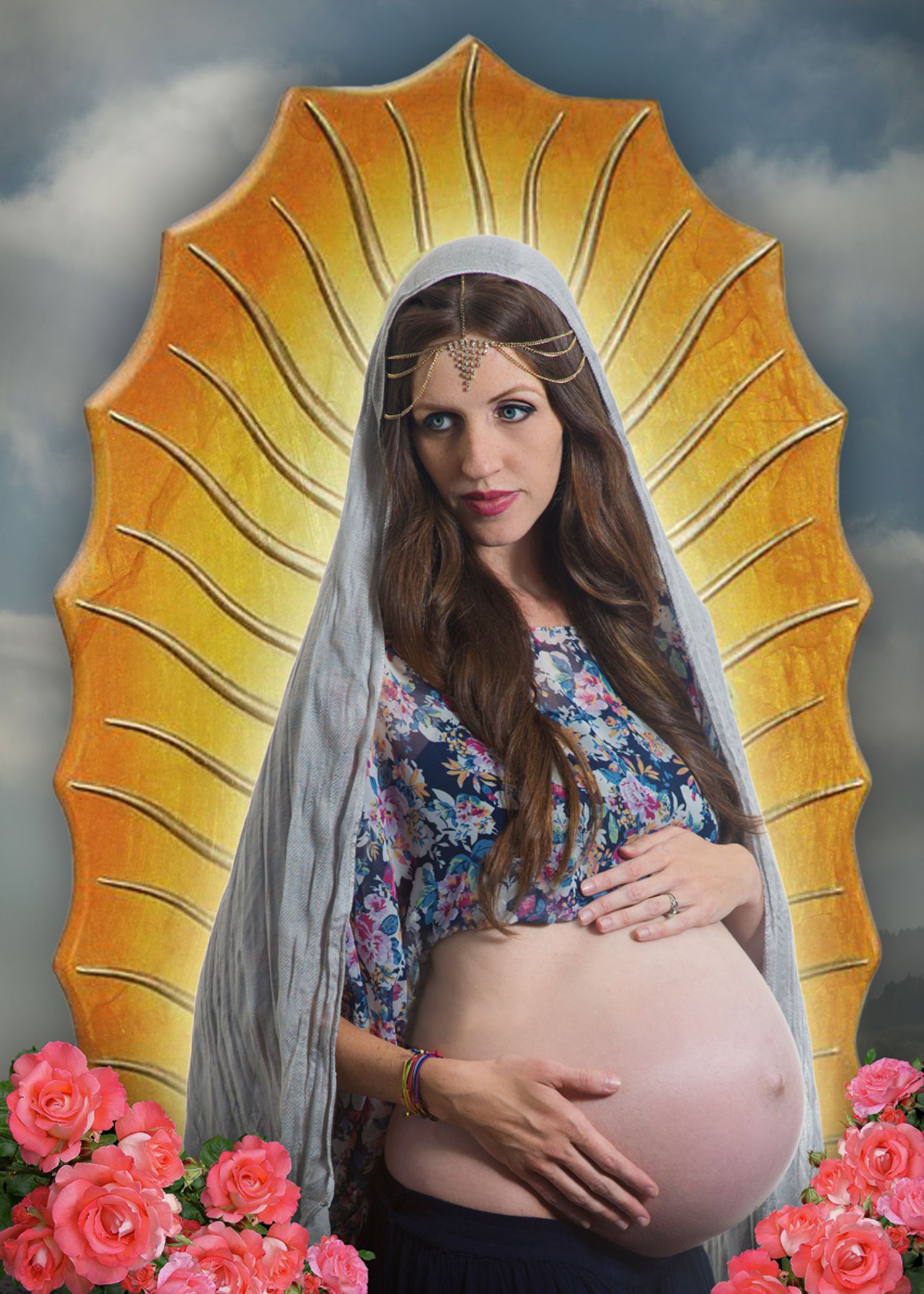 A maternity photoshoot featuring a yellow umbrella backdrop with pink roses and dramatic stormy sky in the background.
