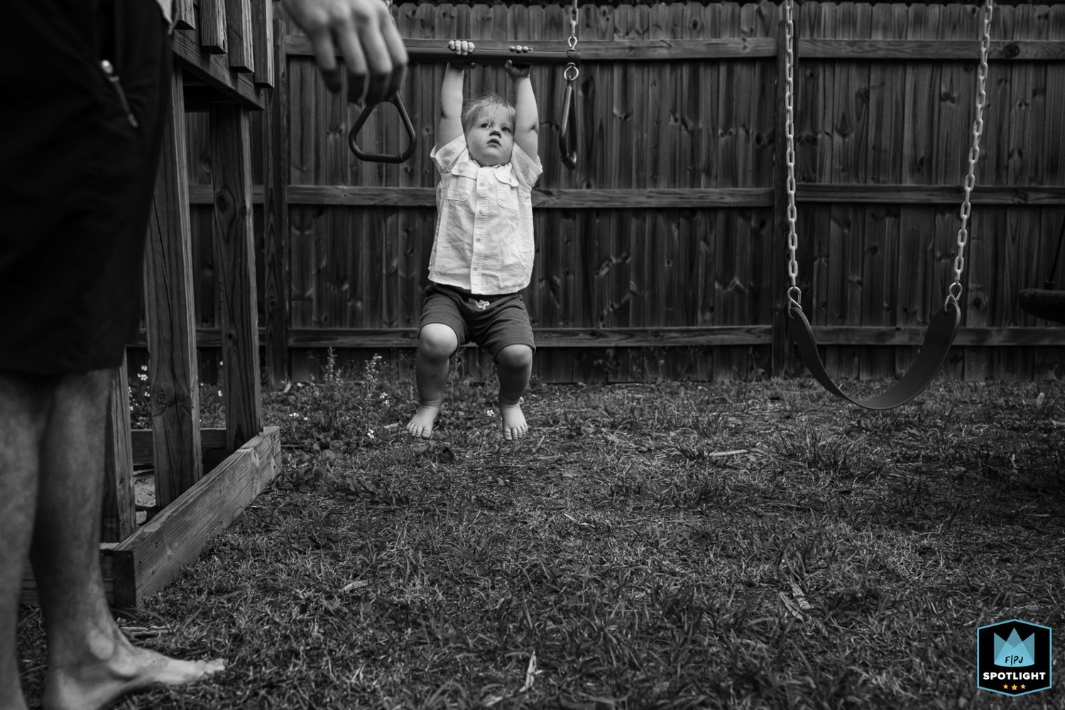 A black and white photo sequence shows a toddler learning to walk on grass while holding someone's hands.