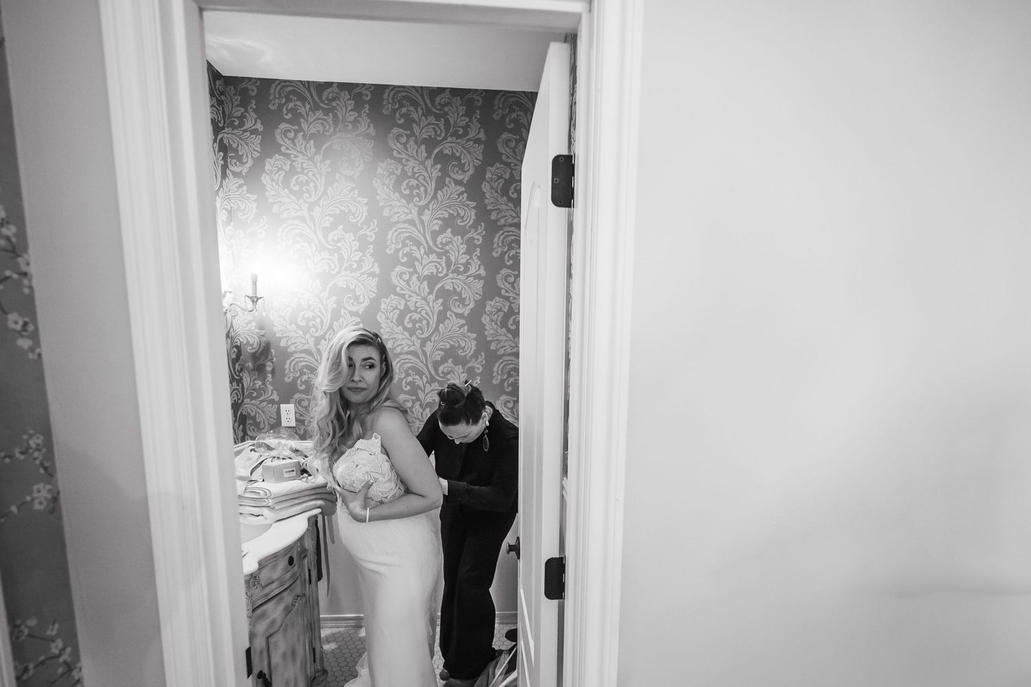 Black and white photo collage showing intimate moments from a wedding ceremony and reception.