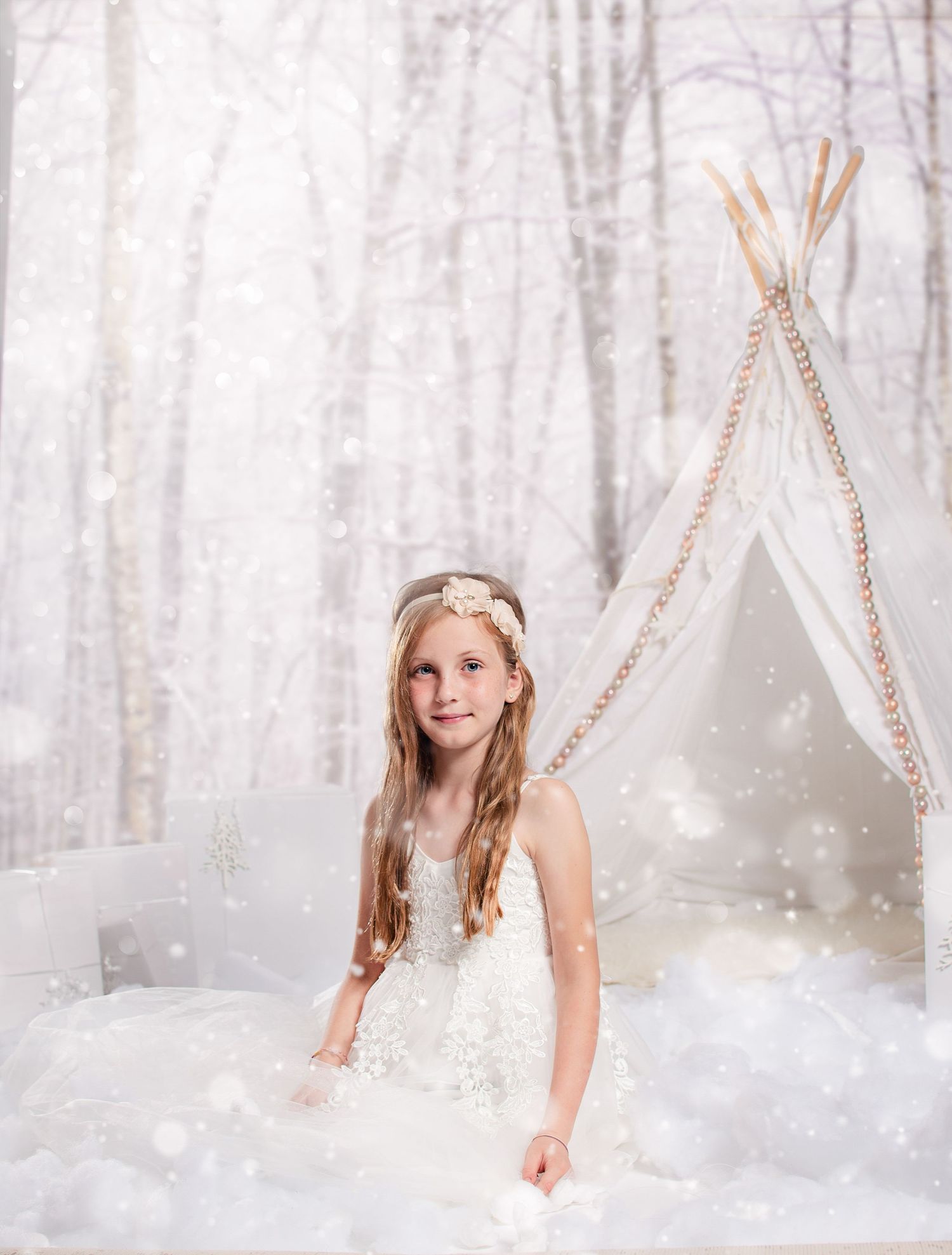 A dreamy winter wonderland scene with teepee tents and twinkling lights in a snowy forest setting.