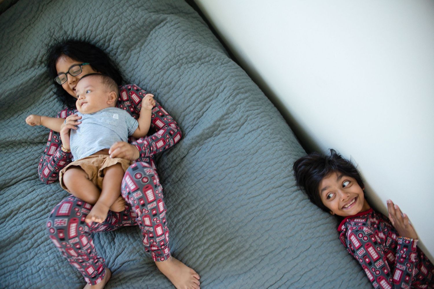 Sequence of relaxed poses on a gray textured surface wearing floral print clothing.