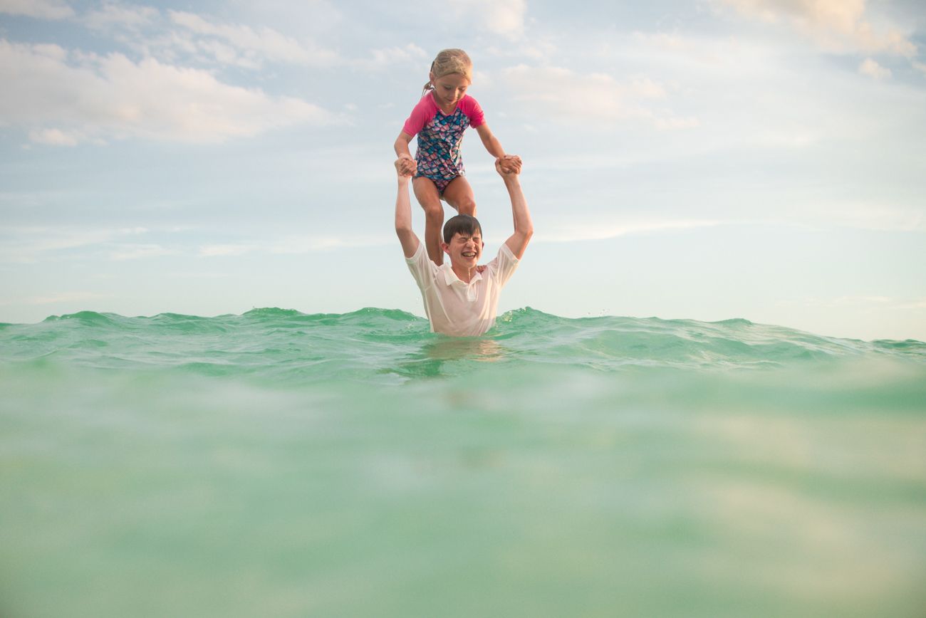 Series of shots showing someone swimming and splashing in turquoise ocean waters.