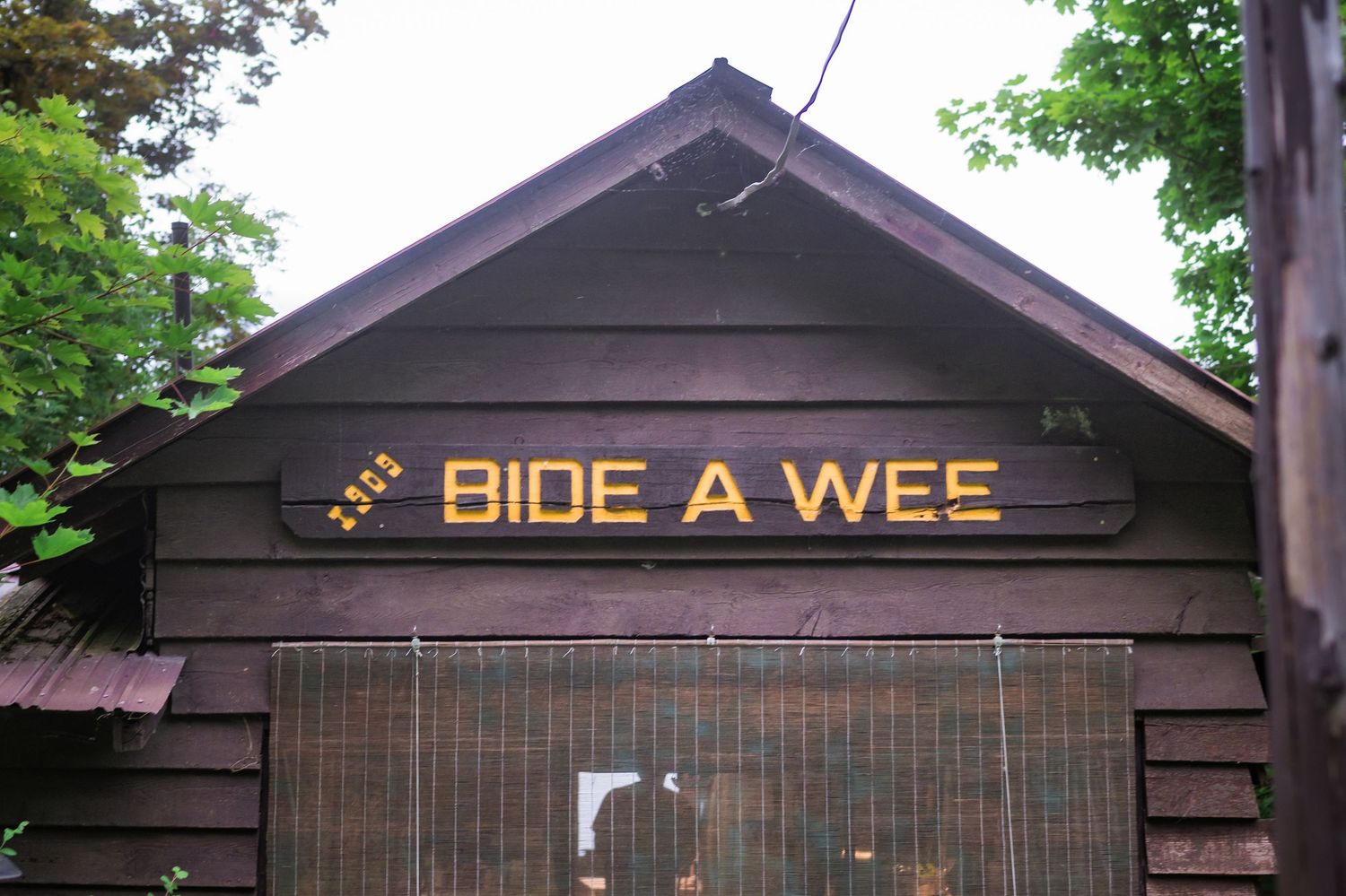 Rustic wooden cabin with a yellow 