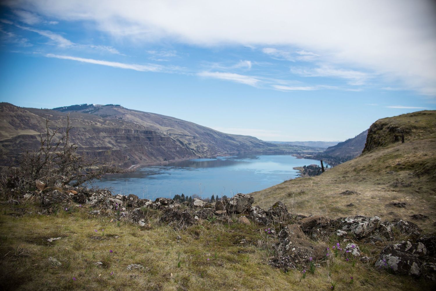 Panoramic mountain landscape series showing rugged terrain and a blue lake nestled between hills under clear skies.