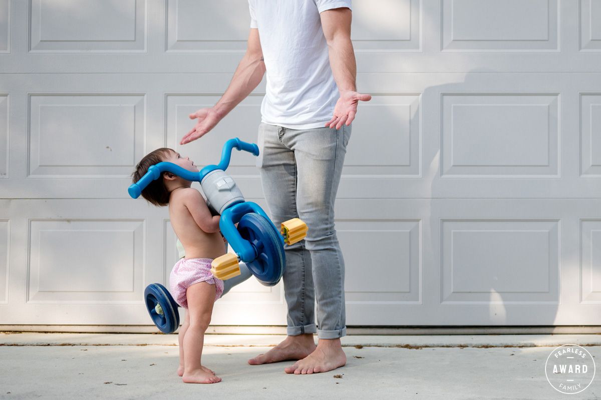 Children playing with bubbles in front of a white garage door.