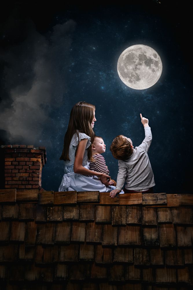 Three children sit on a rooftop under a full moon in a magical night sky scene.