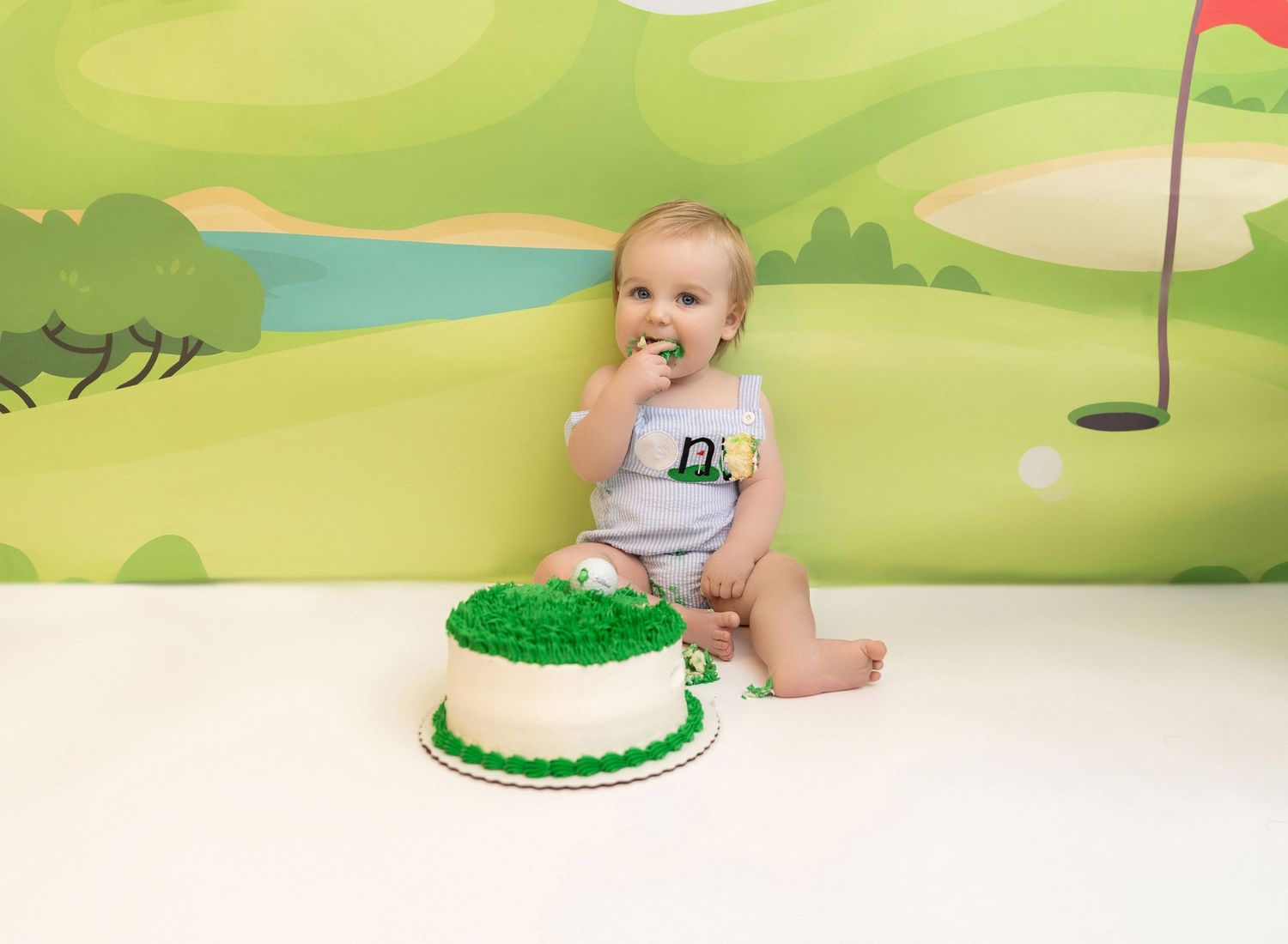 A series of photos showing a baby's first birthday cake smash session on a golf-themed set with green decorations.