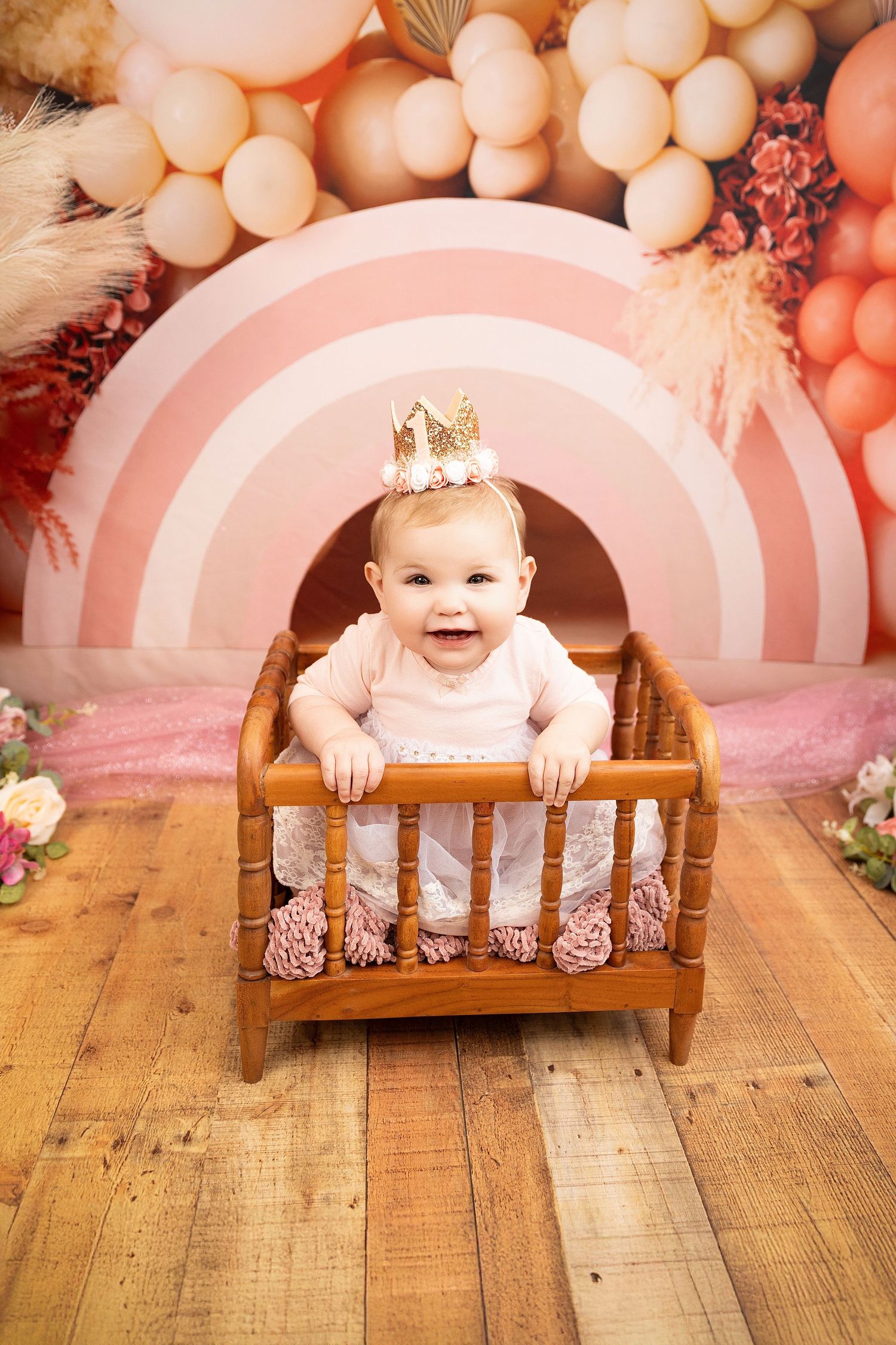Baby photoshoot with pink balloon backdrop and rustic wooden bed prop showing progression of expressions and poses.