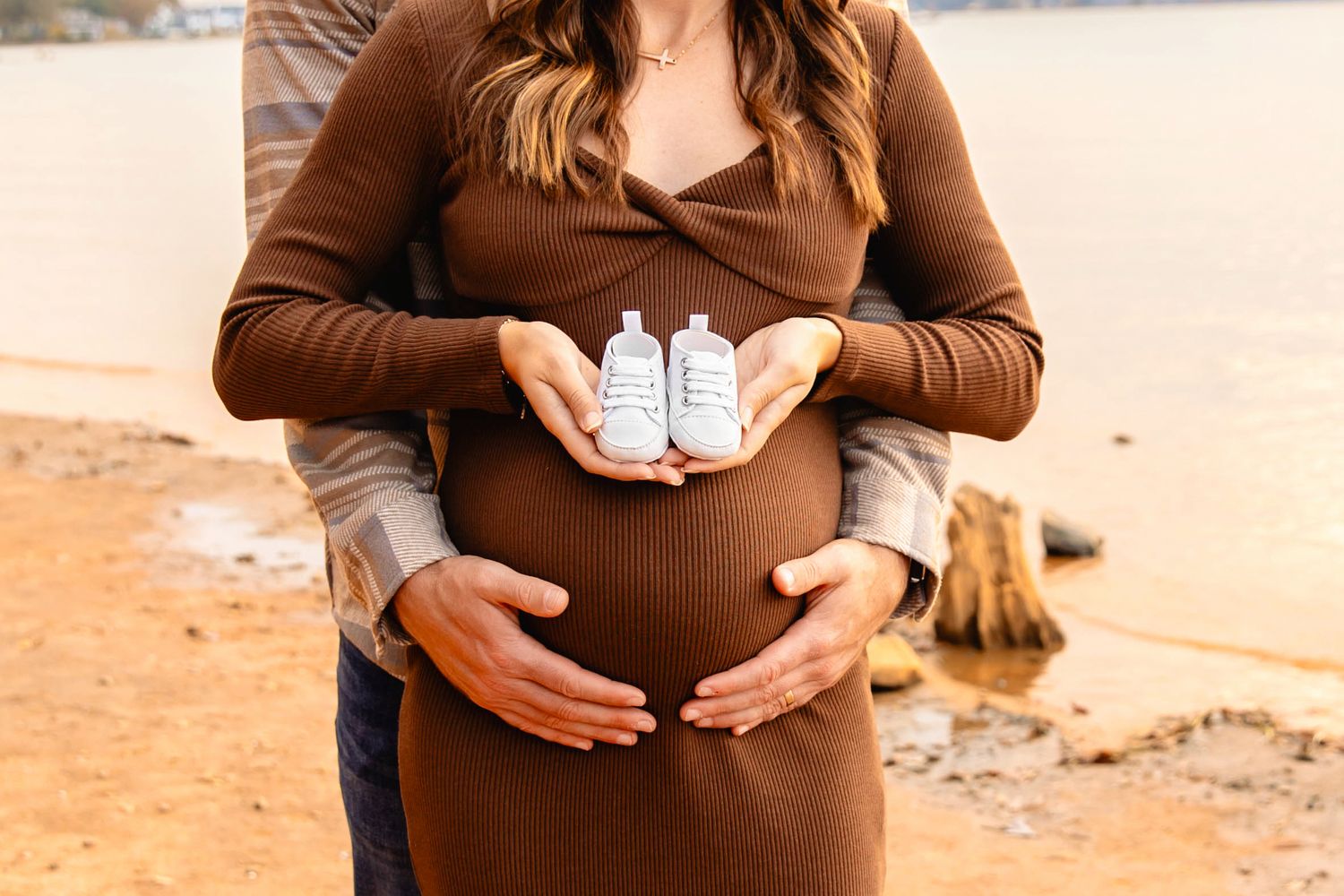 A series of photos showing a pregnant belly growing larger over time, with small baby shoes held in front.