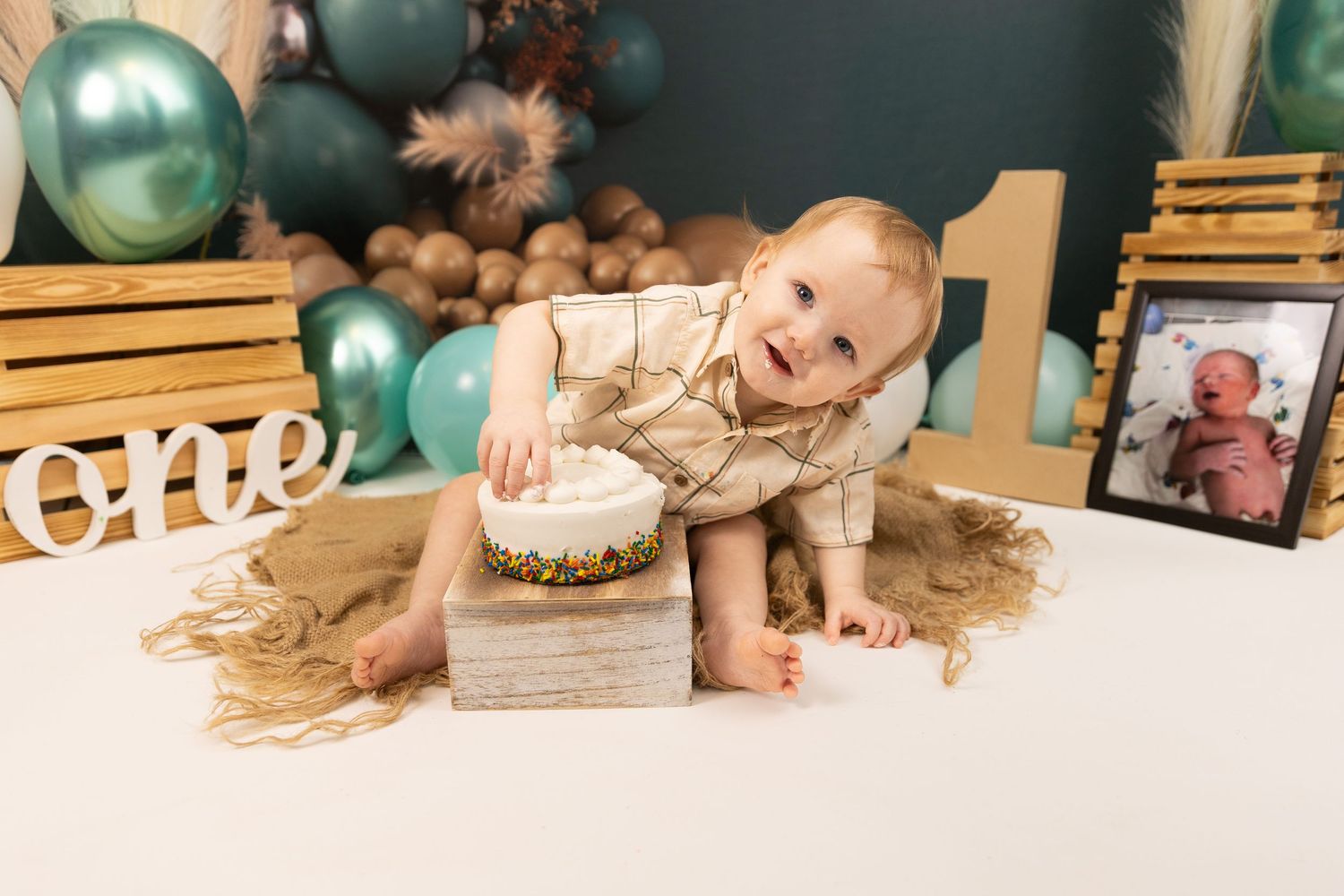 A festive holiday scene with teal and silver ornaments arranged on a wooden surface with decorative elements.