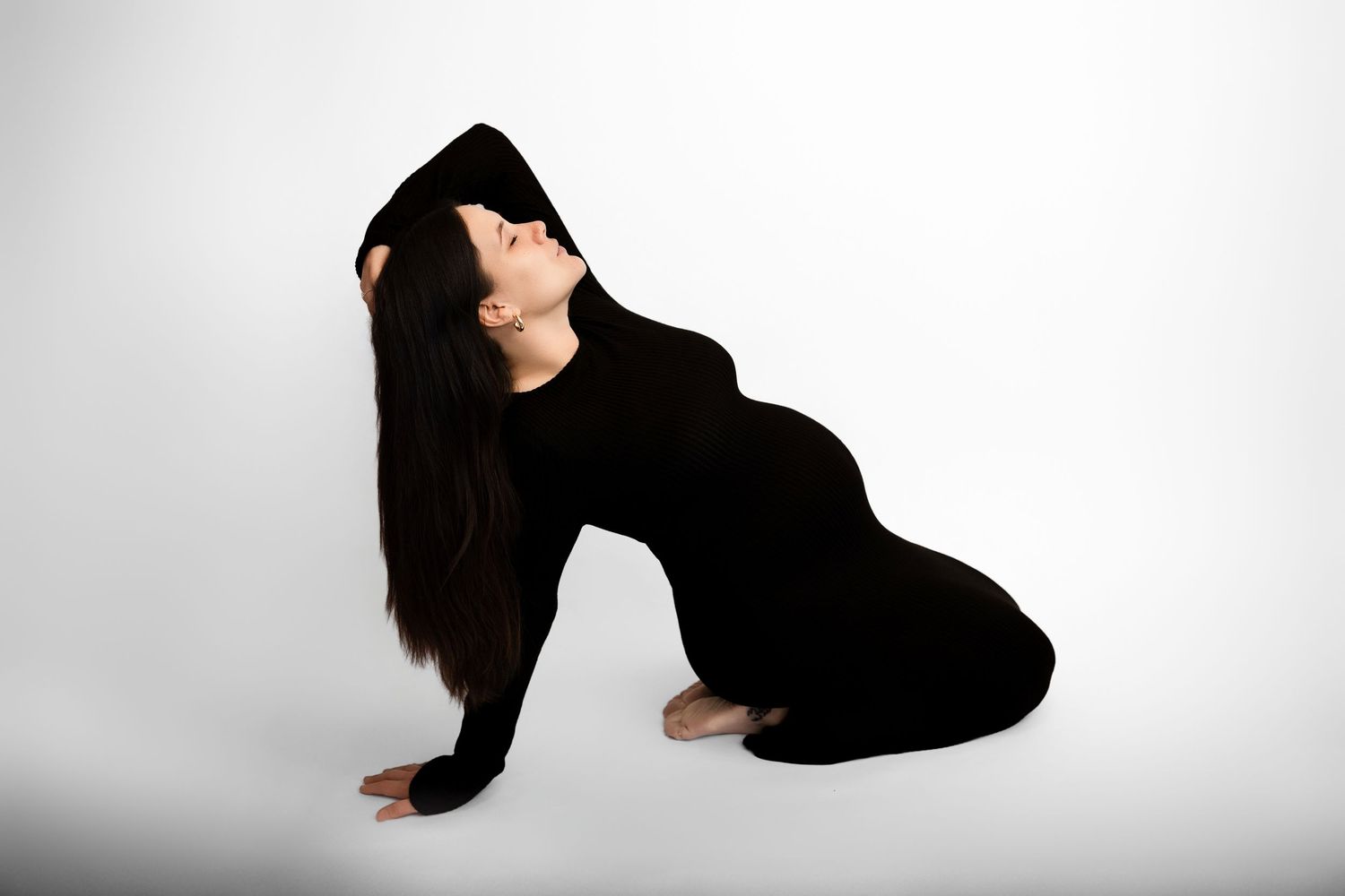 A series of black and white photos showing someone doing a backflip sequence against a white background.