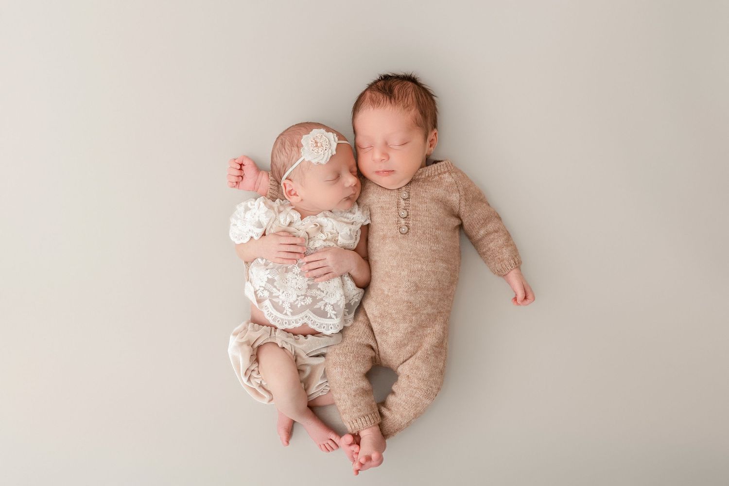 A series of five newborn baby photos showing different sleeping positions on a light beige backdrop.